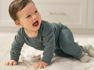 baby boy wearing a football print bodysuit set with pants