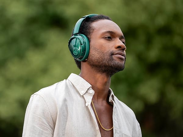 A man wearing lux headphones with be aware mode on outside