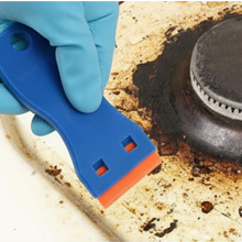 use scraper to remove stubborn residue from kitchen surface