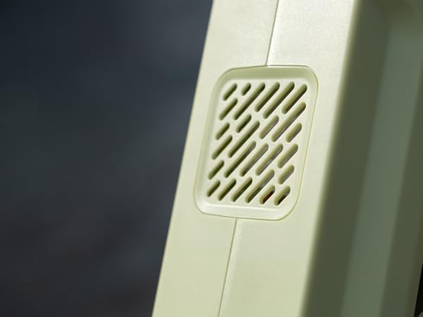 Close-up of a rectangular vented panel, likely a speaker grille or air vent, integrated into a light-colored surface or device frame.