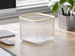 Clear mini trash can beside a computer on an office desk