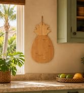 pineapple shaped cutting board hanging in kitchen as wall art