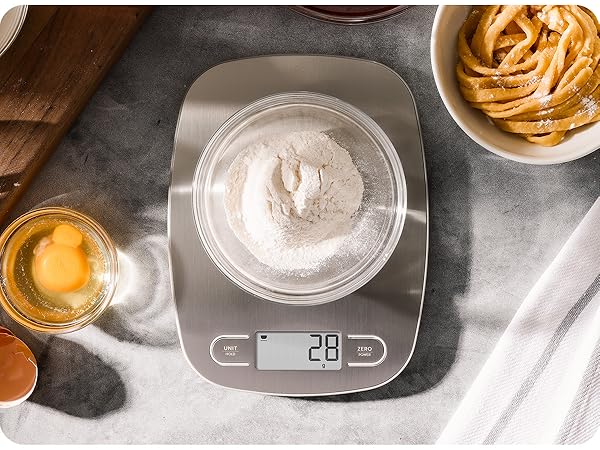 greater goods stainless steel kitchen scale on marble counter weighing bowl of flour