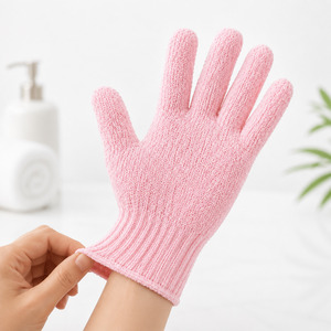Pink exfoliating glove showing its flexible fit and ribbed elastic cuff
