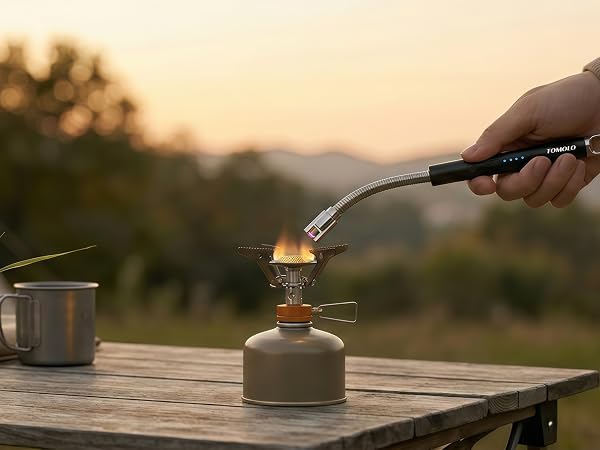 Electric arc lighter lighting a gas stove in kitchen