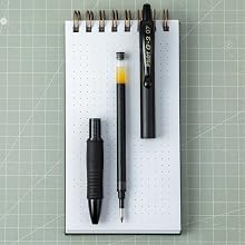 Photo shows deconstructed G2 Edge pen resting on a notebook