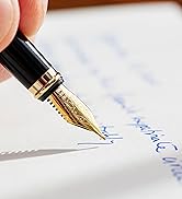 Black and gold fountain pen writing on paper with blue ink