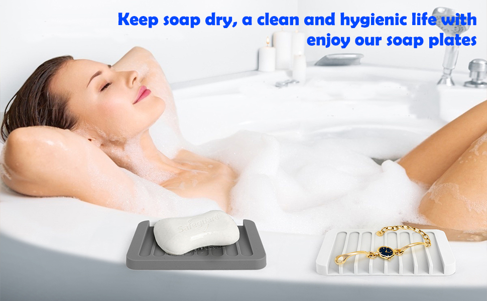 A woman relaxes in a bubbly bathtub. Silicone soap trays keep soap dry for clean hygienic bathing.