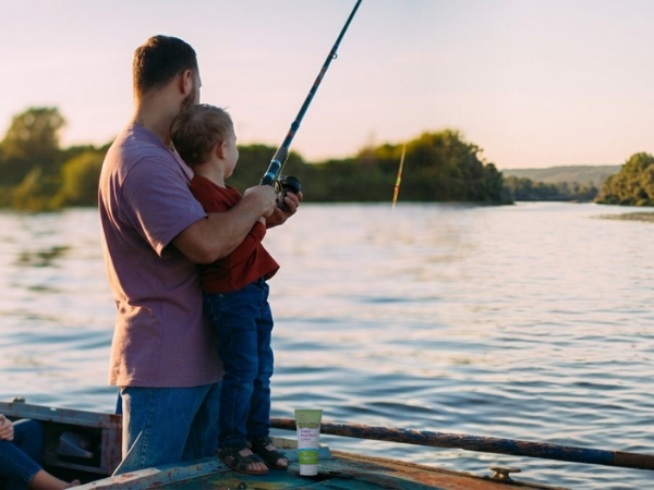 dad and child fishing on a lake