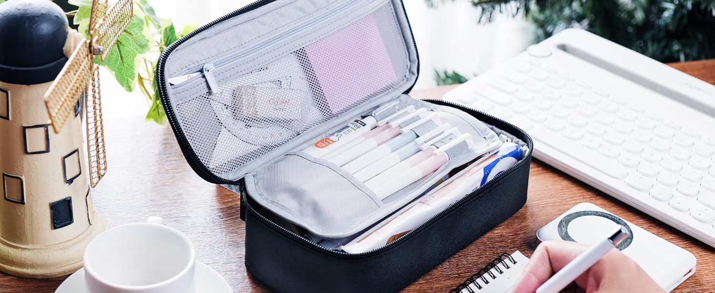 Dark blue travel toiletry bag or organizer shown with transparent compartments, displayed open and being packed with various personal care items.