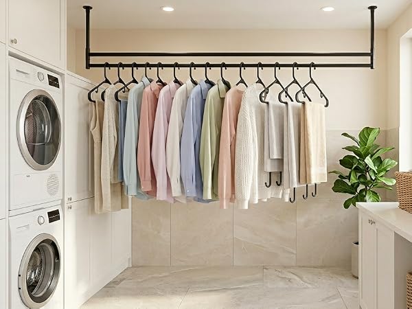 Laundry room: transferring dry clothes onto black hangers straight from dryer. No wrinkling