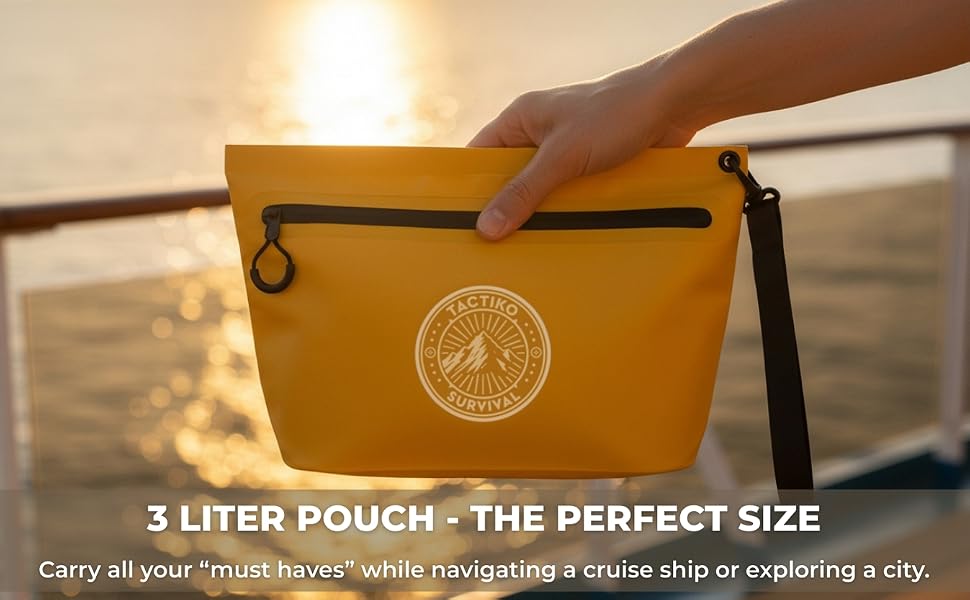 hand holding the yellow pouch by the ship's railing at sunset