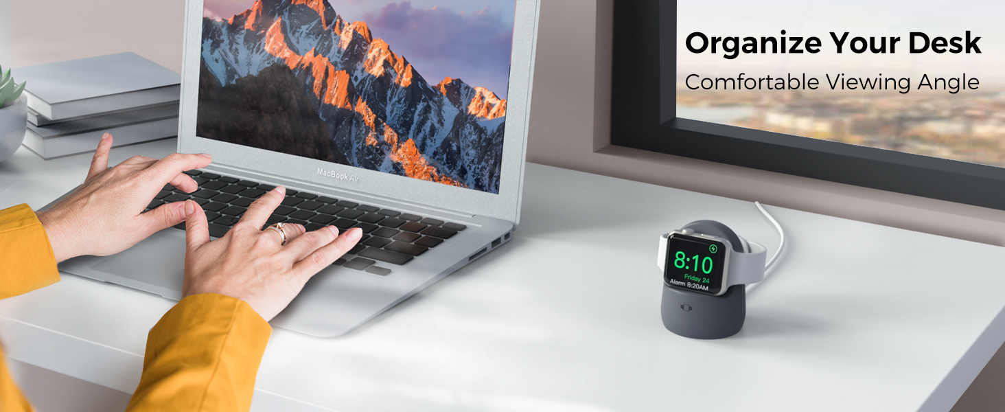 Desk setup with laptop displaying mountain scene, person typing, and small digital clock. Text: 'Organize Your Desk, Comfortable Viewing Angle'.