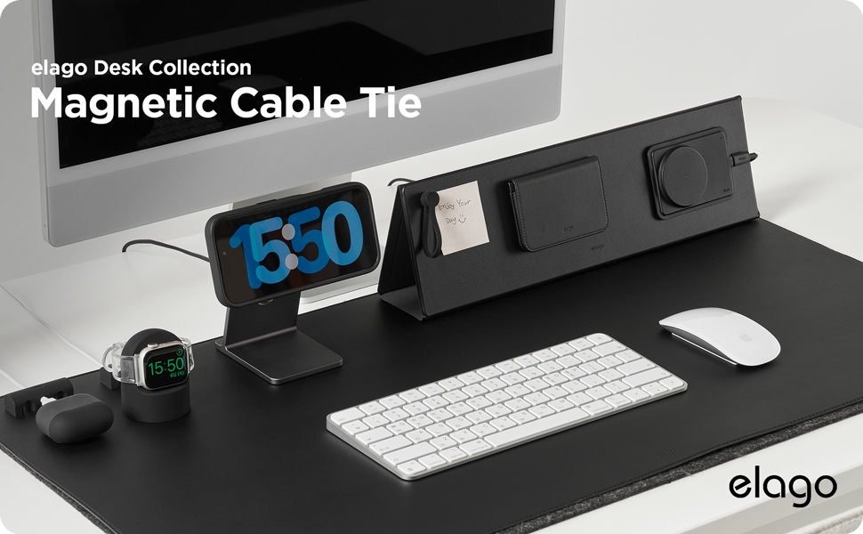 Text reads "elago Desk Collection Magnetic Cable-Tie". Black desk organizer setup with magnetic cable tie holding blue cable marked "5.0", white wireless keyboard, computer mouse, and green desk lamp on black surface.