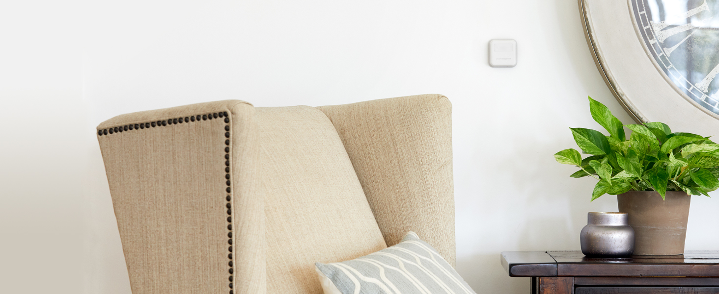 Smart Sensor on wall of living room next to mirror.