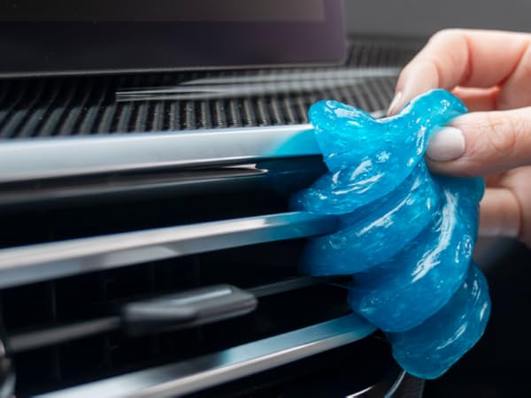Car cleaning gel lifting dust from tight vents and dashboard crevices for interior detailing