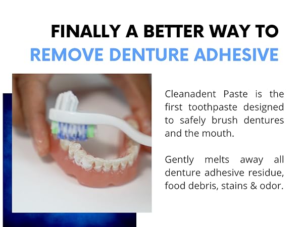 Hand holding denture and brushing it with toothbrush