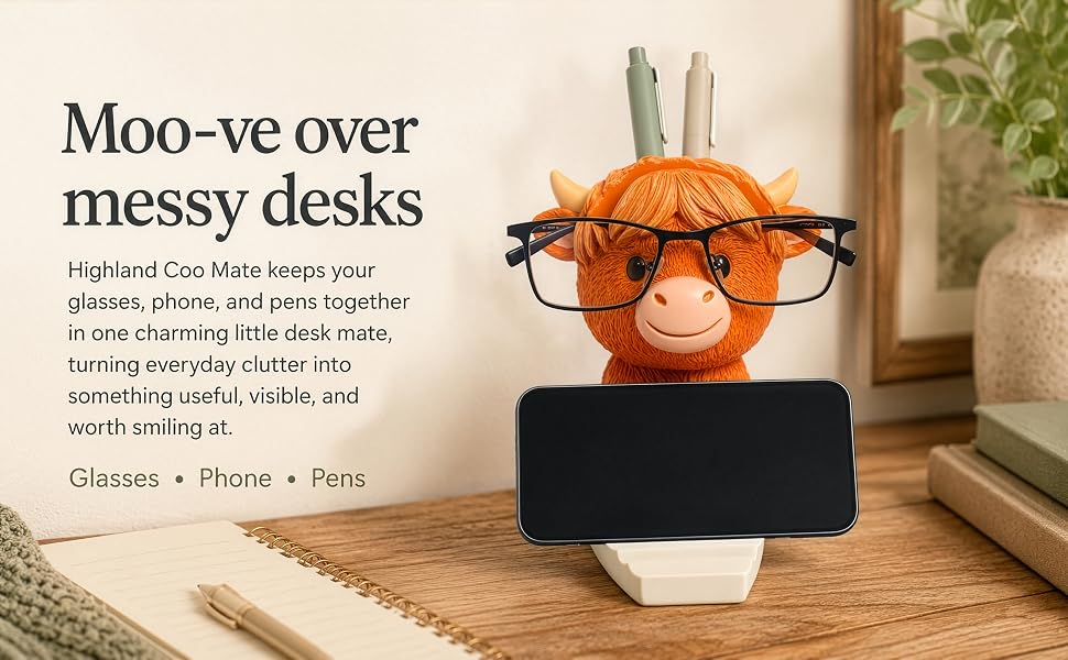 Highland cow desk organizer holding glasses phone and pens on cozy home office desk