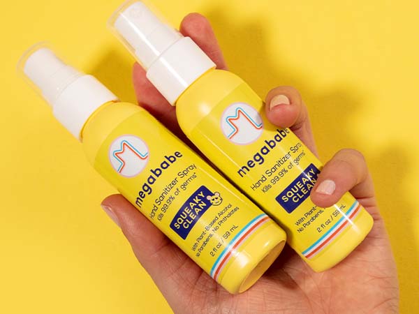 Hand sanitizer spray on yellow background.