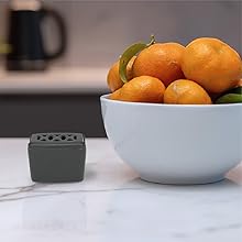 Lifestyle image of the discreet and compact flying insect trap stored on the kitchen counter
