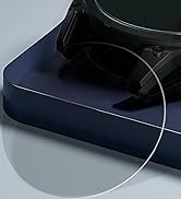 Close-up of a turntable on a dark blue base. A transparent circular disc, likely a platter or record, is visible in the foreground.