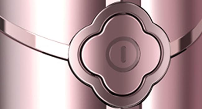 Close-up of a decorative rose gold or copper-colored quatrefoil-shaped connector or design element with metallic finish and curved edges.
