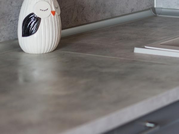 Series of images showing modern gray concrete countertops with seamless joints and clean edges in what appears to be a kitchen installation setting.