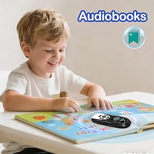 Text reads 'Audiobooks'. Child sitting at table with picture book and black audio device, focusing on interactive learning experience.
