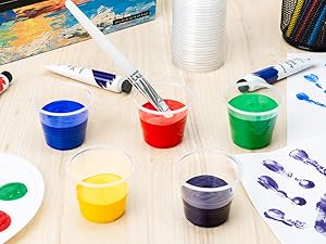 Various colors of paint in small clear plastic cups.