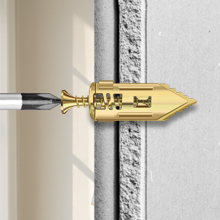 Hold your item (e.g., shelf bracket) in place and thread the screw through it into the anchor.