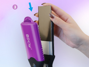 Purple hair styling tool with ribbed handle being inserted into a tan-colored case. Hand shown holding the case open.