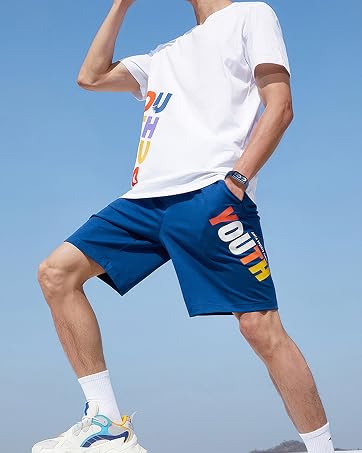 Athletic wear demonstration showing blue shorts with white trim in multiple poses against blue sky background.