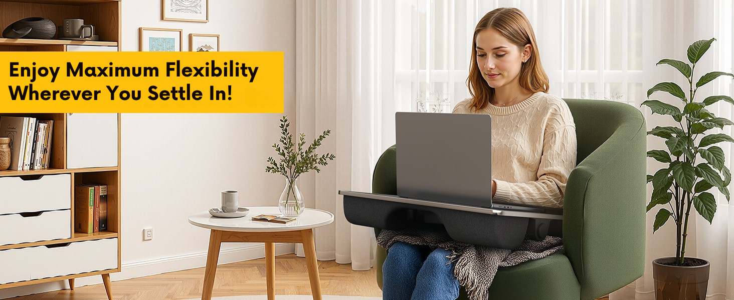 Woman using laptop lap desk with leg support while seated in armchair near bright window.