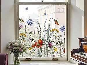 Series of window views showing decorative floral decals featuring colorful wildflowers, butterflies, and hummingbirds applied to glass panes.