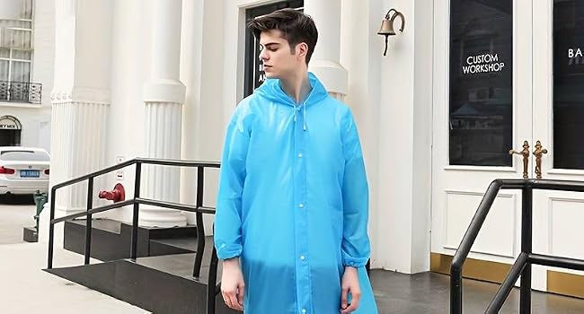Long light blue raincoat with button front closure and hood, shown in outdoor urban setting