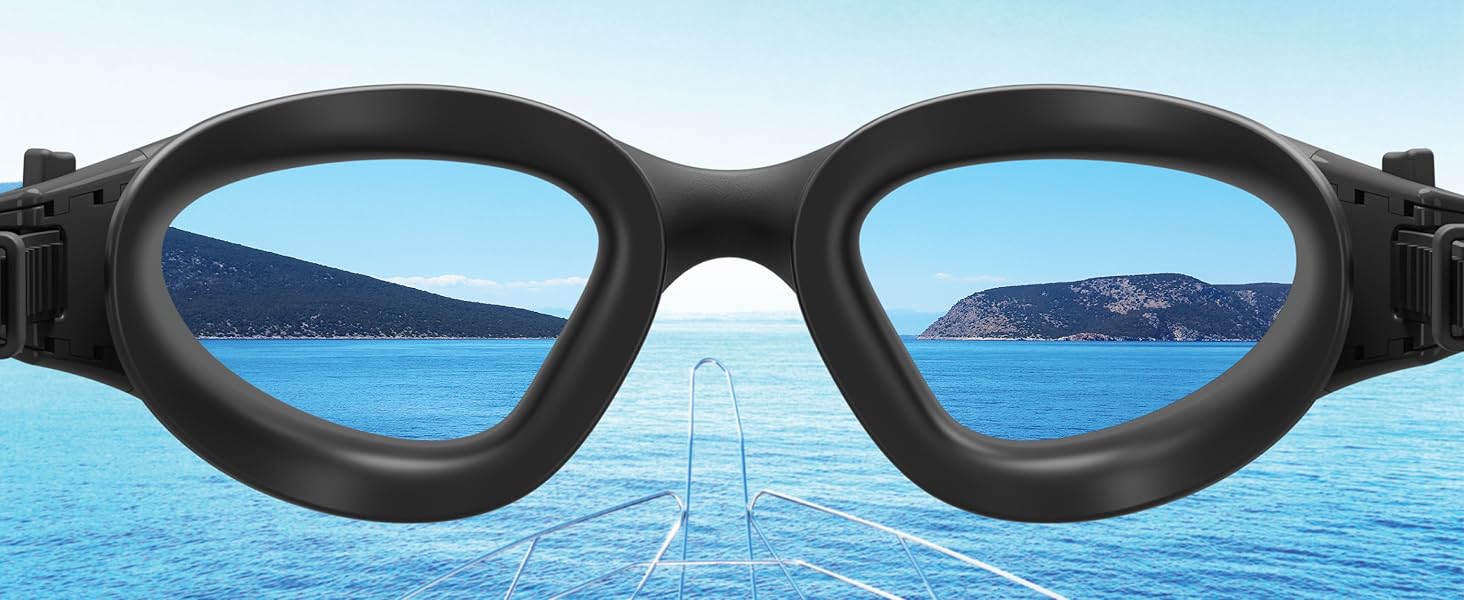 Black swimming goggles shown against a seascape background, emphasizing their use for water activities and clear vision underwater.