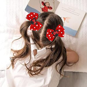 Red polka dot hair bows with white spots, styled in a playful pattern with Minnie Mouse-inspired design.