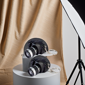 A wooden table with the product displayed alongside various photography accessories.