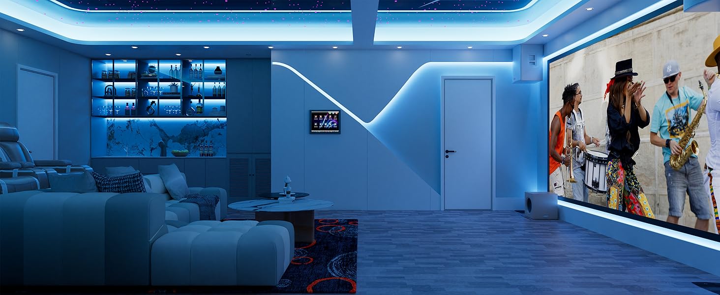 Modern living room with blue LED lighting, large sectional sofa, and wall-mounted projector screen displaying a concert image. Built-in shelving and cabinetry visible in background.