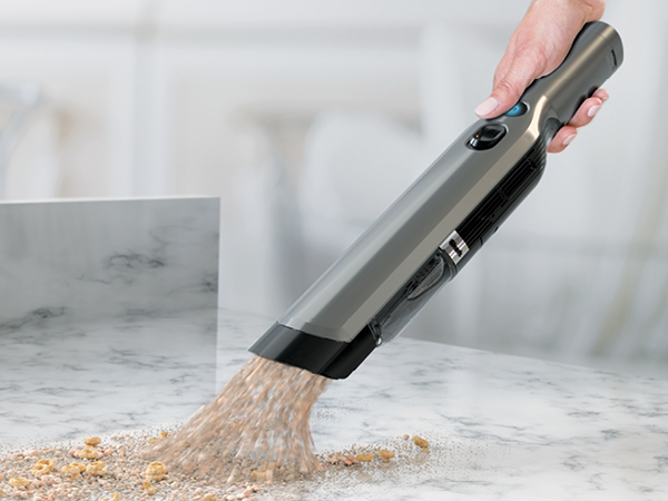 wandvac picking up cheerios from counter