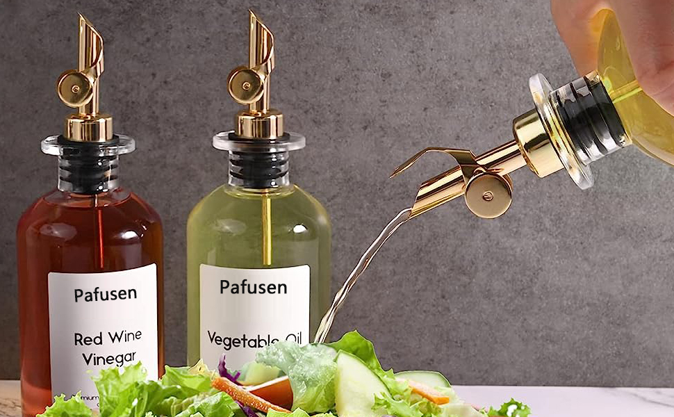 a bottle of liquid being poured into a salad