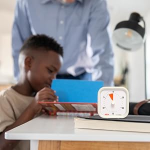 Time Timer MOD 30 Minute visual timer sitting on desk with young boy and father reading.