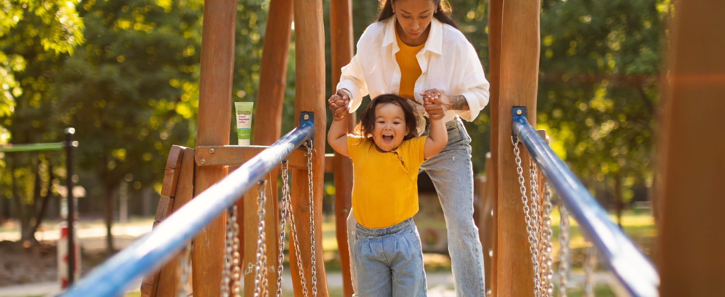 mother and child playing outside on the playground