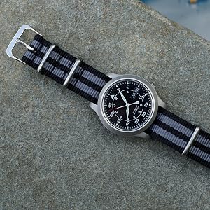 Black and Grey Striped Nylon Watch Band on Black Watch against Granite Background