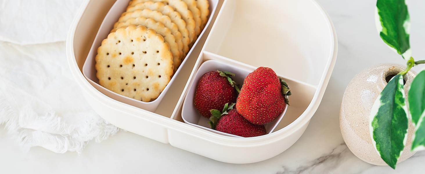 White square and rectanlge silicone baking cups in a lunch box with crackers and fruit