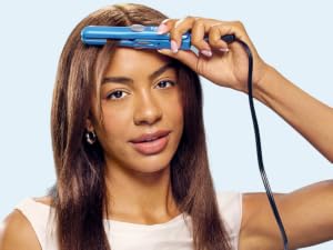 Woman straightening hair