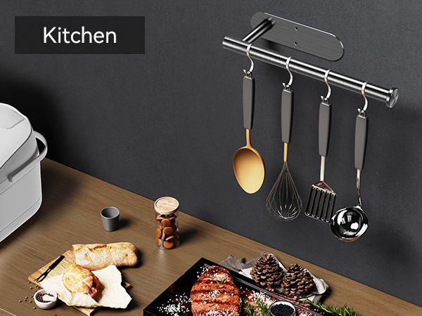 Black wall mounted holder used as kitchen utensil rail beside countertop appliances
