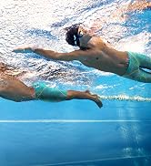 Man and boy wearing arena Powerskin ST Next jammers in Fireflow pattern in a beautiful outdoor pool
