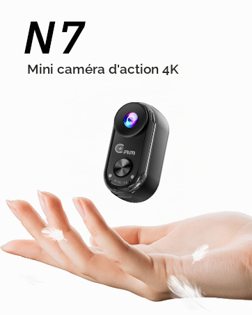 Text reads "N7" and "Mini cámara de acción 4K". Compact black action camera device held in palm of hand, showing small form factor and ergonomic design for portable video recording.