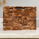 Natural wood cutting boards, serving tray, salad bowls displayed as kitchen essentials